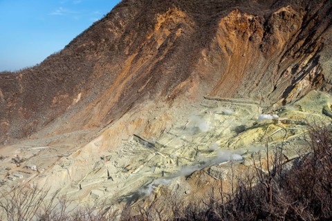 Steaming fumaroles in the Owakudani geothermal area at Komagatake volcano, Hakone, Japan