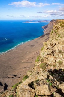 Castillejo viewpoint, view from the Risco de Famara cliffs to the coast and the sea with the Famara
