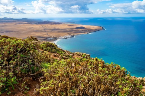 View from the Castillejo viewpoint from the Risco de Famara cliffs to the coast and the sea with