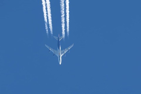 Boeing 747 jumbo jet cargo aircraft of Atlas air airlines flying in a blue sky with contrails or