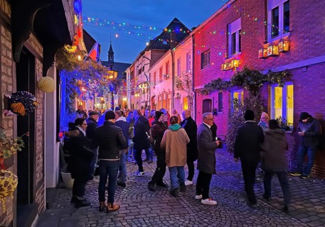 People in the Tiefstraße decorated for the Martin train in the evening, historic old town, Kempen,