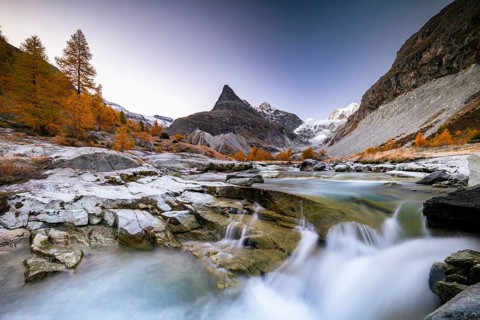 Mountain stream with autumnal larches and mountain views, Mont Mine, Ferpecle glacier, Val