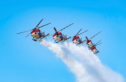 Indian Air Force (IAF) ALH Mk1 Sarang helicopters soar through the sky during an air show as part