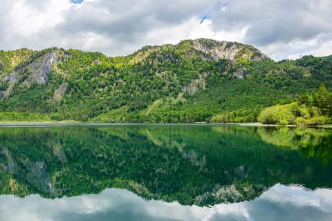 Landscape of Lake Offensee after rain when the sun comes through the clouds in spring,