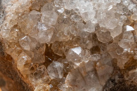 Vibrating quartz crystals mix with rock formations and capture light in a natural spring atmosphere