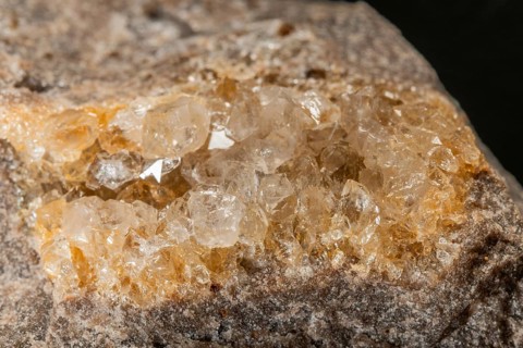 Translucent crystals shimmer in granite rocks. The discovery takes place in summer in a quiet,