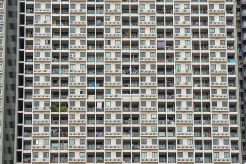 Exterior façade of a residential high-rise building of Condo U (a brand or series name of the Thai