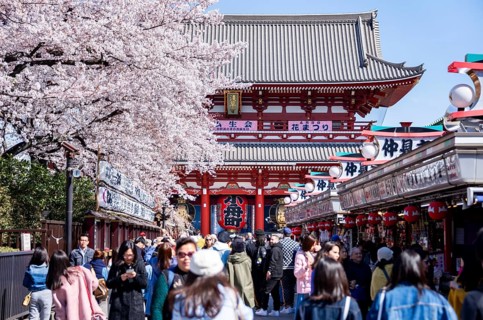 View of numerous visitors on Nakamise-dori shopping street with Hozomon Gate of Asakusa Shrine or