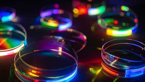Abstract background of slightly unfocused multicolored glass lenses spinning and rotating,