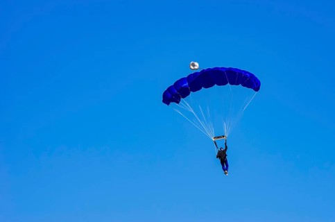 Skydivers during an aerial acrobatic performance as part of an air show at the Fliegerbergfest of