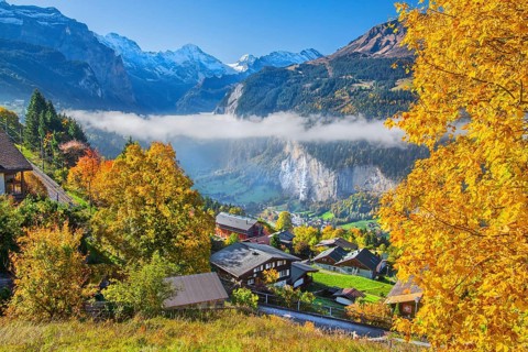 View from the village of the Lauterbrunnen Valley with Staubbach waterfall in autumn with morning