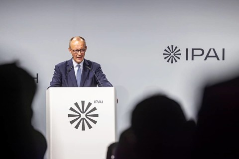 Federal Chancellor Friedrich Merz (CDU) . Portrait at the lectern with free text space.
