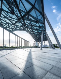Modern architectural framework with glass and steel structure, glass facade with a greed of steel
