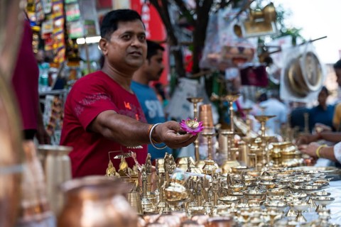 People shop for bronze and other metal items at a roadside stall on Dhanteras, in Guwahati, Assam,