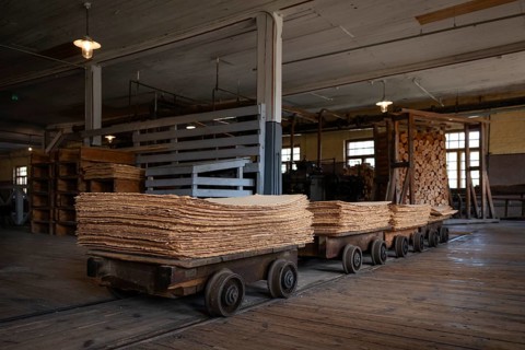 Wagon on rails for transporting cardboard, former paper factory and mill for the production of