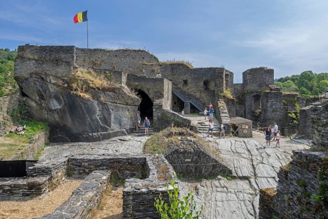 9th century medieval ruined hill castle overlooking the city La Roche-en-Ardenne in summer,