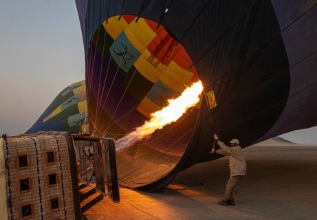 In order to get ready for the take-off, the pilot inflates the balloon with hot air by activating