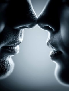 Symmetrical arrangement of two pairs of lips coming close together creates a feeling of intimacy,
