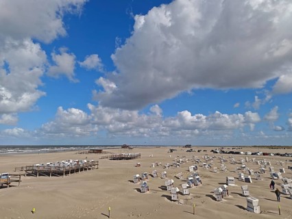 North Sea beach with sand drifts, car park, blue sky, white clouds, summer, sun, beach chairs, on