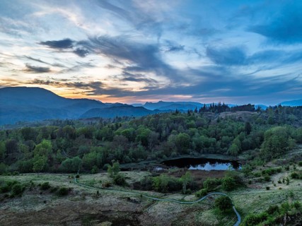 Sunset over Mountains and Coniston Water from drone, Lake District National Park, Cumbria, England,