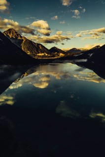 Sunrise with reflections and alpenglow in Lake Heiterwanger See in Tyrol in the Alps in Austria