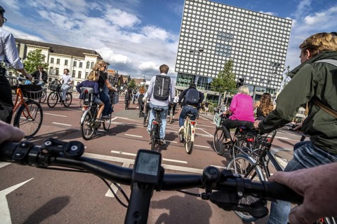 Ride your bike on the central cycle path on Lange Viestraat, Vredenburg, in the city centre of