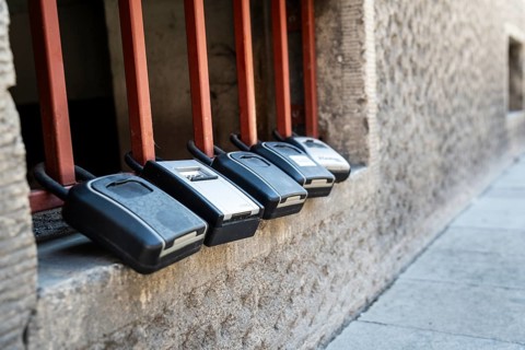 Key boxes on a grille of a basement window for flat flats in the city centre of Bratislava,