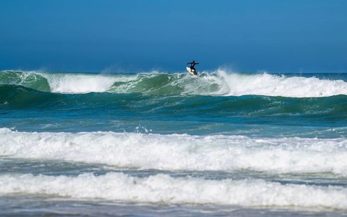 Surfer riding a wave on Contis beach, Saint Julien en Born, Saint-Julien-en-Born, Landes, France