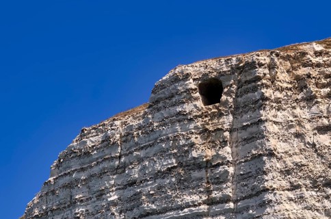 View of the Eye of the Panda, L'oeil du Panda, rock window, cave, in the rock arch Falaise