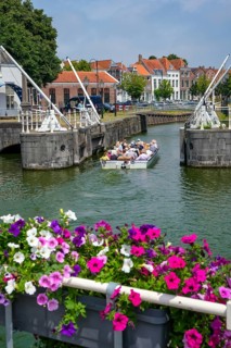 Middelburg, Zeeland, Netherlands - Town houses on the inner harbour in the old town. Tourists take