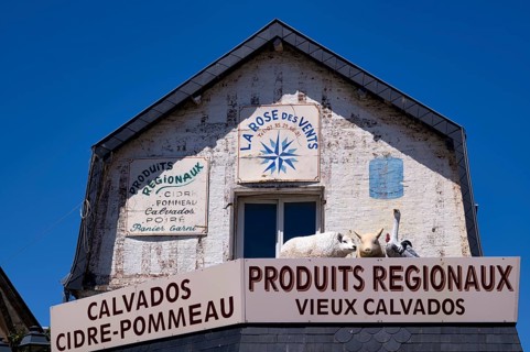 Advertising sign La Rose des Vents. Retail trade, supplier of regional products such as Calvados,
