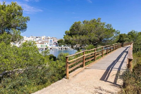 Portocolom fishing village on Majorca with boats and colourful houses Holiday by the sea in