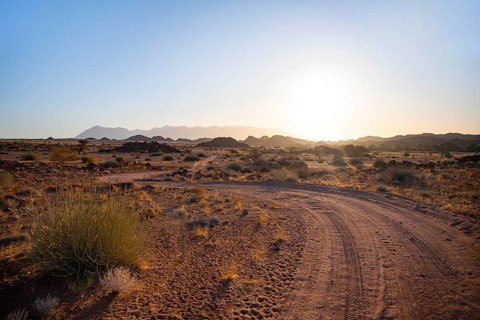 Sandy track, desert landscape in the evening light at sunset, backlit, Brandberg, Erongo,