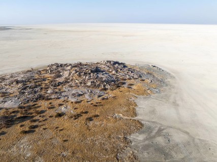Rocky island with baobab trees in a dry salt pan, aerial view, Kubu Island, Botswana