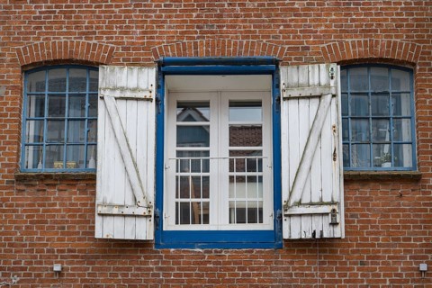 Window with shutters, brick façade, warehouse building, old town centre, Husum, North Frisia,