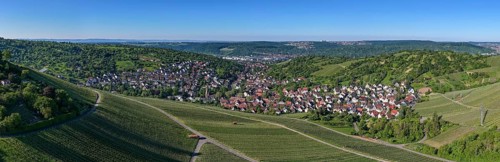 Widescreen panorama of a village surrounded by vineyards and green hills, Uhlbach, near Stuttgart,