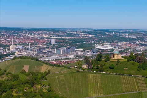 Panoramic view over Stuttgart with vineyards in the foreground and urban skyline behind, view of