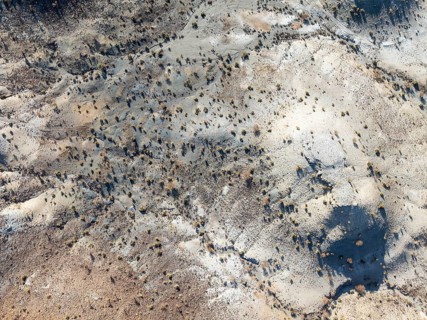Broken, rocky ground with sparse vegetation. Aerial view. Drone shot. Southern Namibia