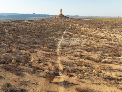 The Vingerklip (rock finger) is surrounded by thornbush and mopane (Colophospermum mopane) savanna.