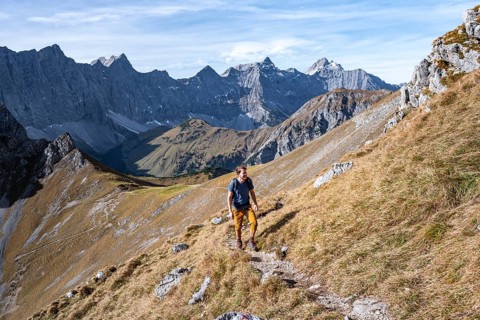 Mountaineers on a hiking trail at the Gamsjoch, picturesque mountain landscape in autumn, view of