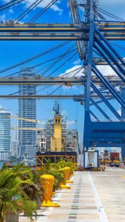 Busy international industrial port with freight and shipment docks and cargo containers
