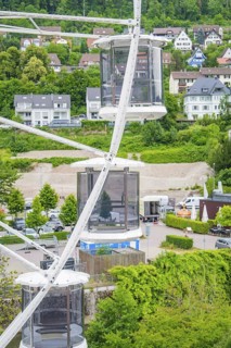 View from the Ferris wheel with a view of houses and wooded hills in the background, Ferris wheel