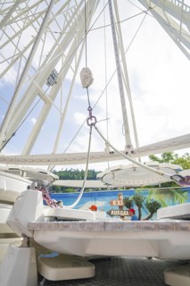 View from below of the structure of a Ferris wheel in front of a blue sky, Ferris wheel
