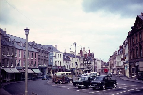Cars parked in Market Place square, town of Cirencester, Gloucestershire, England, UK 1960s