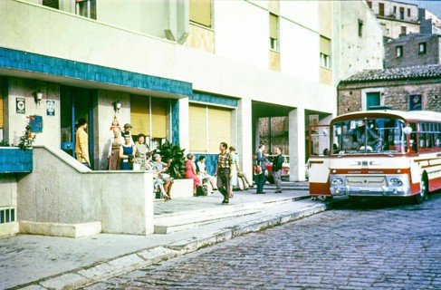 People outside hotel waiting to board tour bus coach, Piazza Armerina, Sicily 1960s