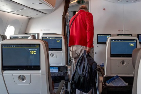 Etihad Airways passenger with backpack, Abu Dhabi, United Arab Emirates