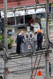 Electricians working on power lines, Pattaya, Thailand