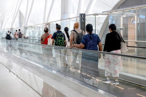 Airport moving walkway Passengers with hand luggage, Abu Dhabi, United Arab Emirates