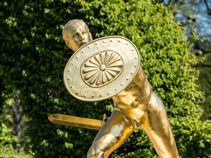 Golden sculpture, warrior with shield and sword, Herrenhausen Gardens, Baroque garden at castle