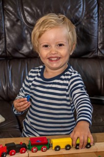 Blond boy, 2 years old, playing with toy train in Ystad, Skåne County, Sweden, Scandinavia